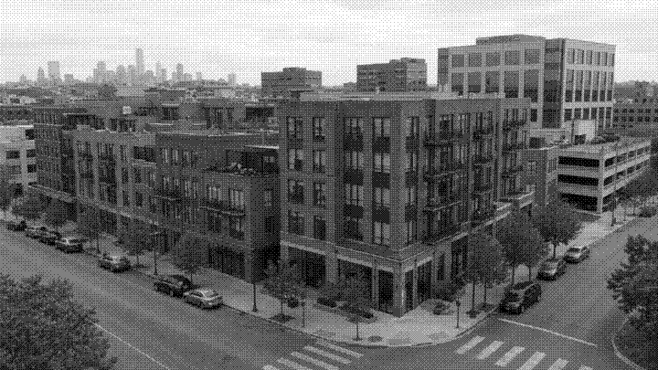 A mixed-use brick block of ground-floor retail and apartments, downtown towers behind
