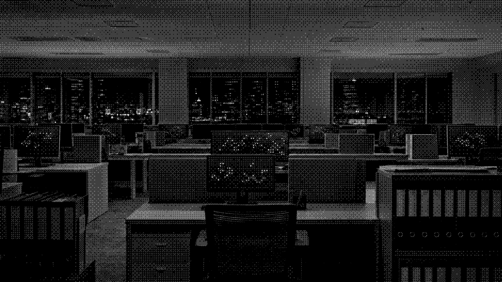 An open floor of monitors at night, each carrying part of the record