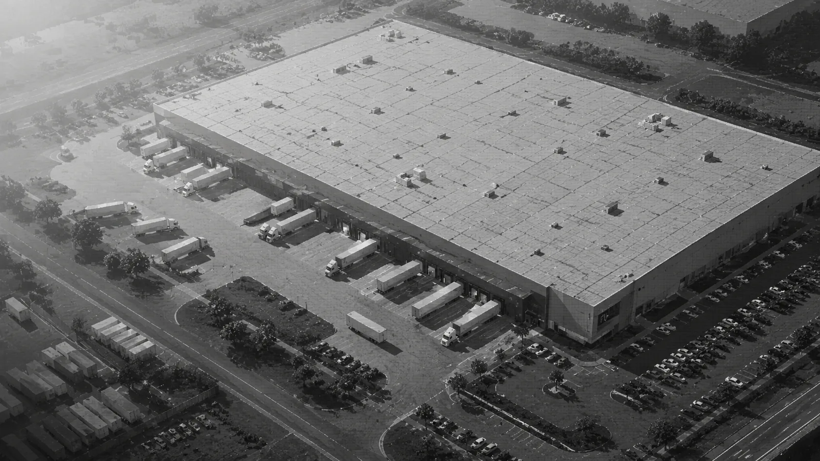 Large industrial building and yard seen from above